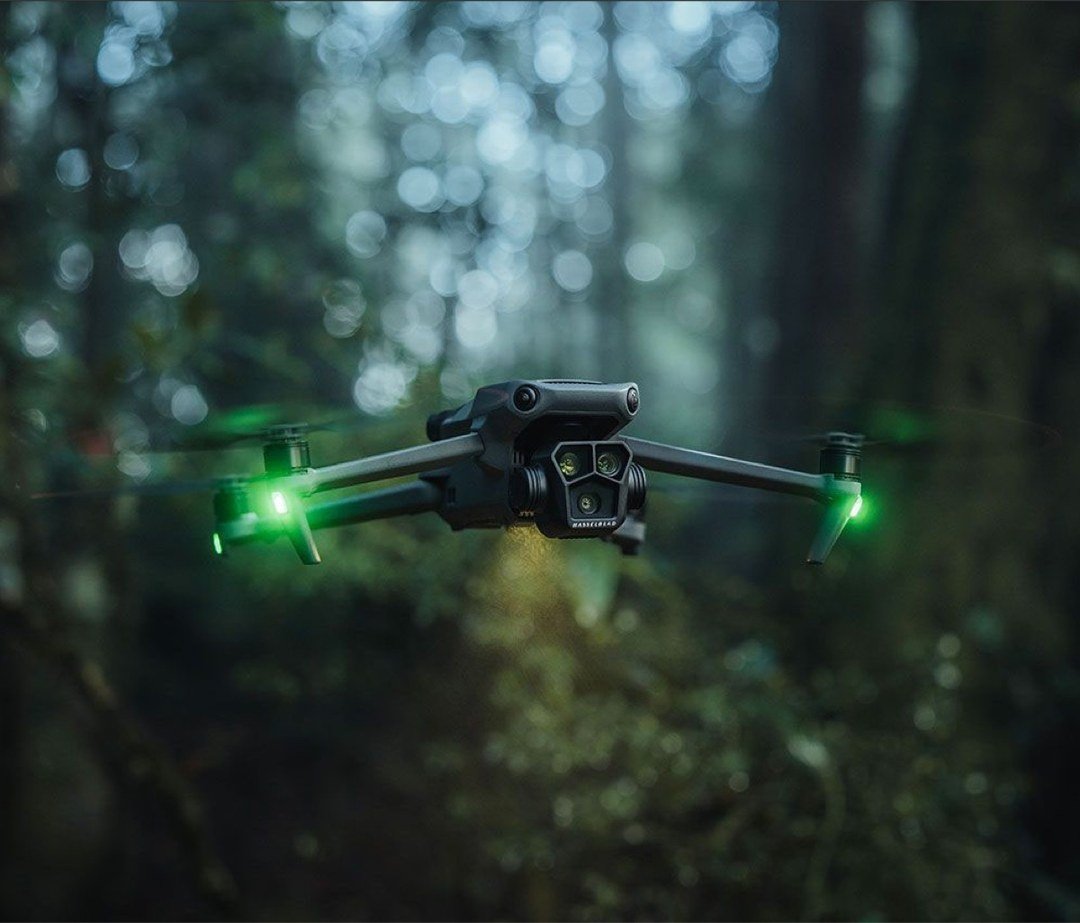 Dron con luces LED verdes volando en el bosque